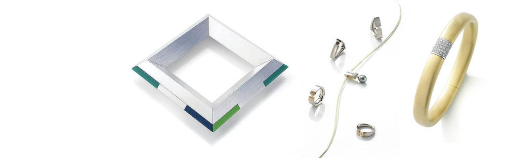 Slidermotiv Handwerkskunst - verschiedene moderne und klassische Schmuckstücke auf weiß glänzendem Untergrund